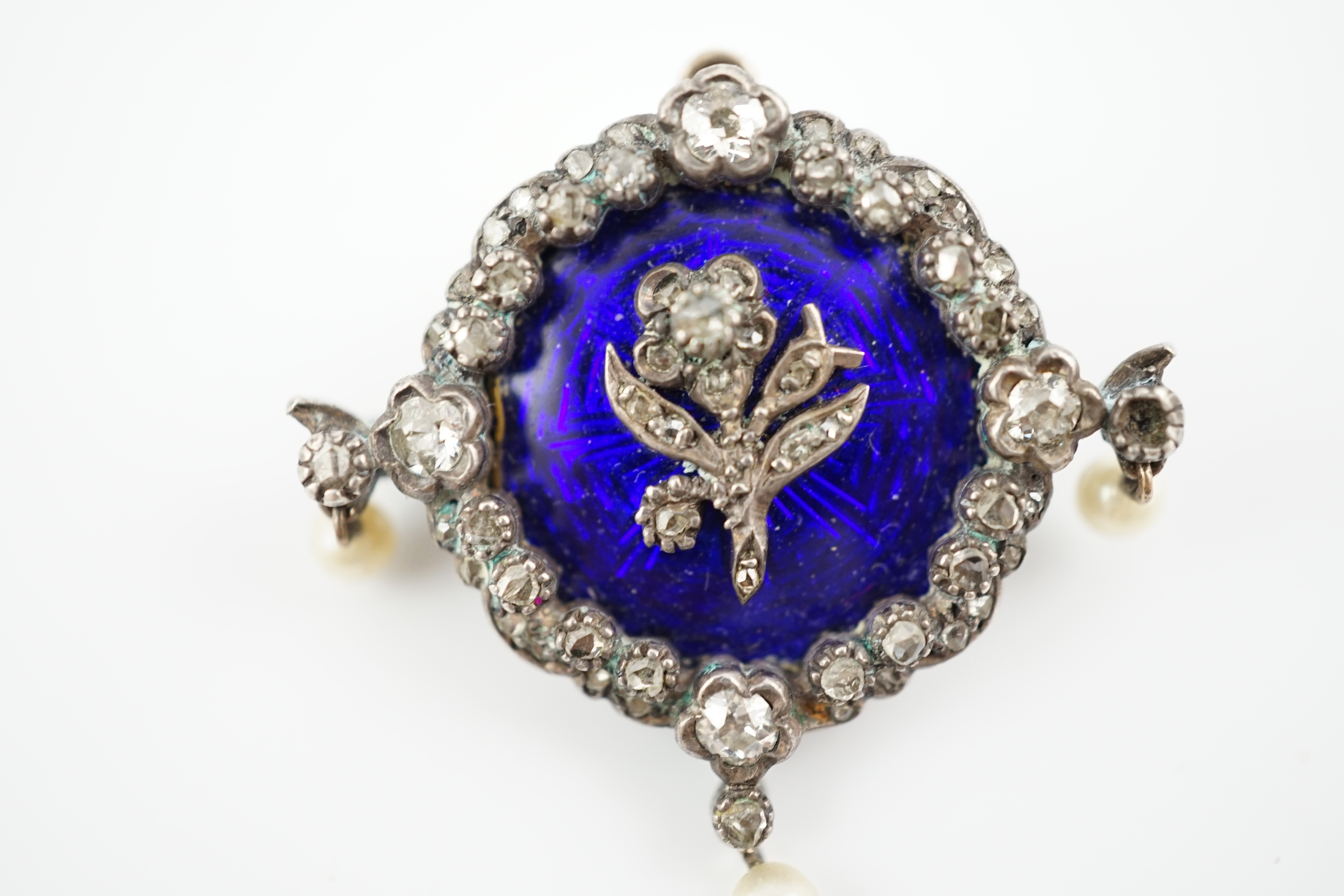 An Edwardian gold, enamel, diamond and seed pearl set drop brooch